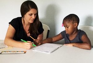 Kim Rohlfing tutors a child through the Boys & Girls Club program in Bloomington.